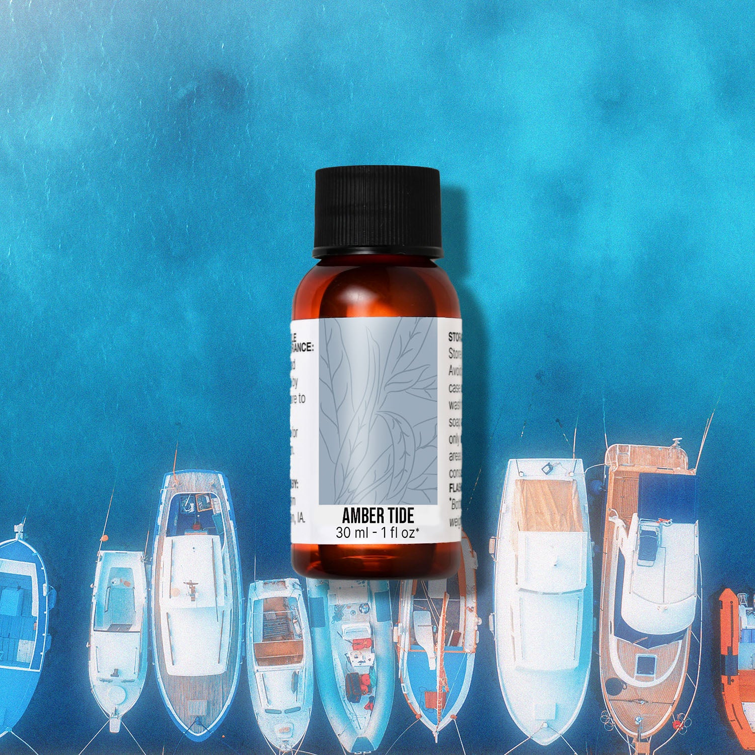 Bottle of Amber Tide fragrance oil with illustrated boats on a blue background