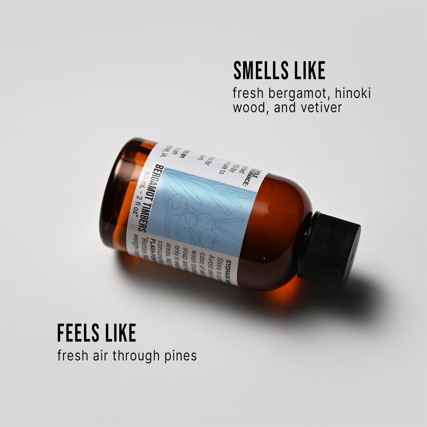 Bottle of Bergamot Timbers fragrance oil with a label on a white background, describing its scent.