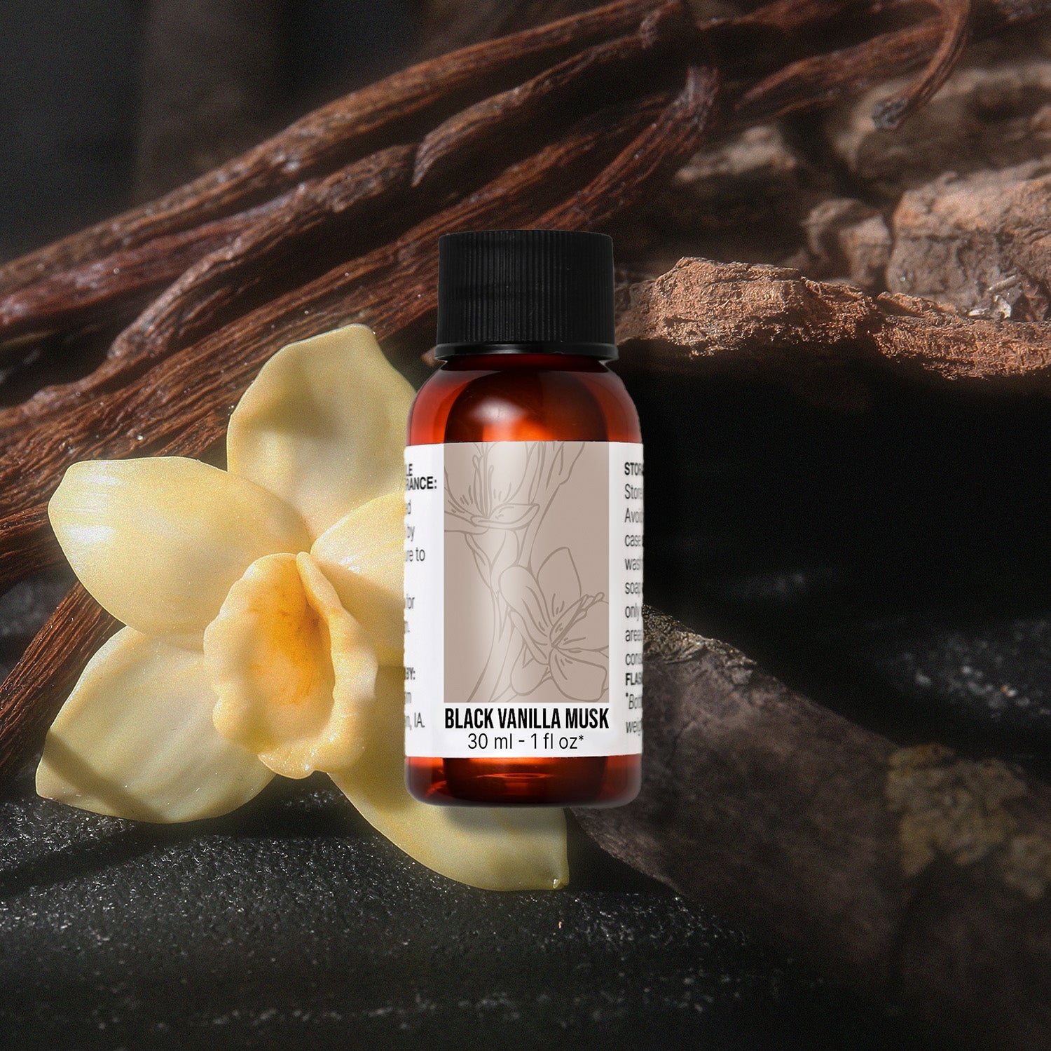 Bottle of Black Vanilla Musk fragrance oil with vanilla beans and flowers on a dark background