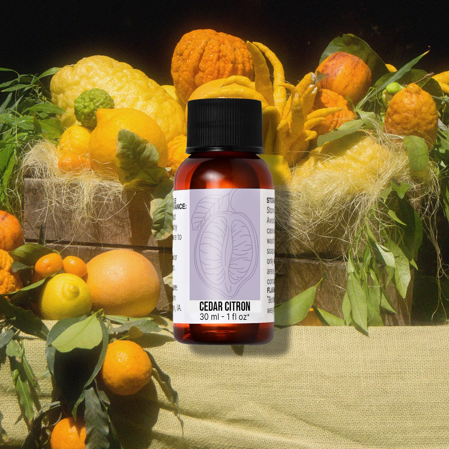 Bottle of Cedar Citron fragrance oil with citrus fruits in the background