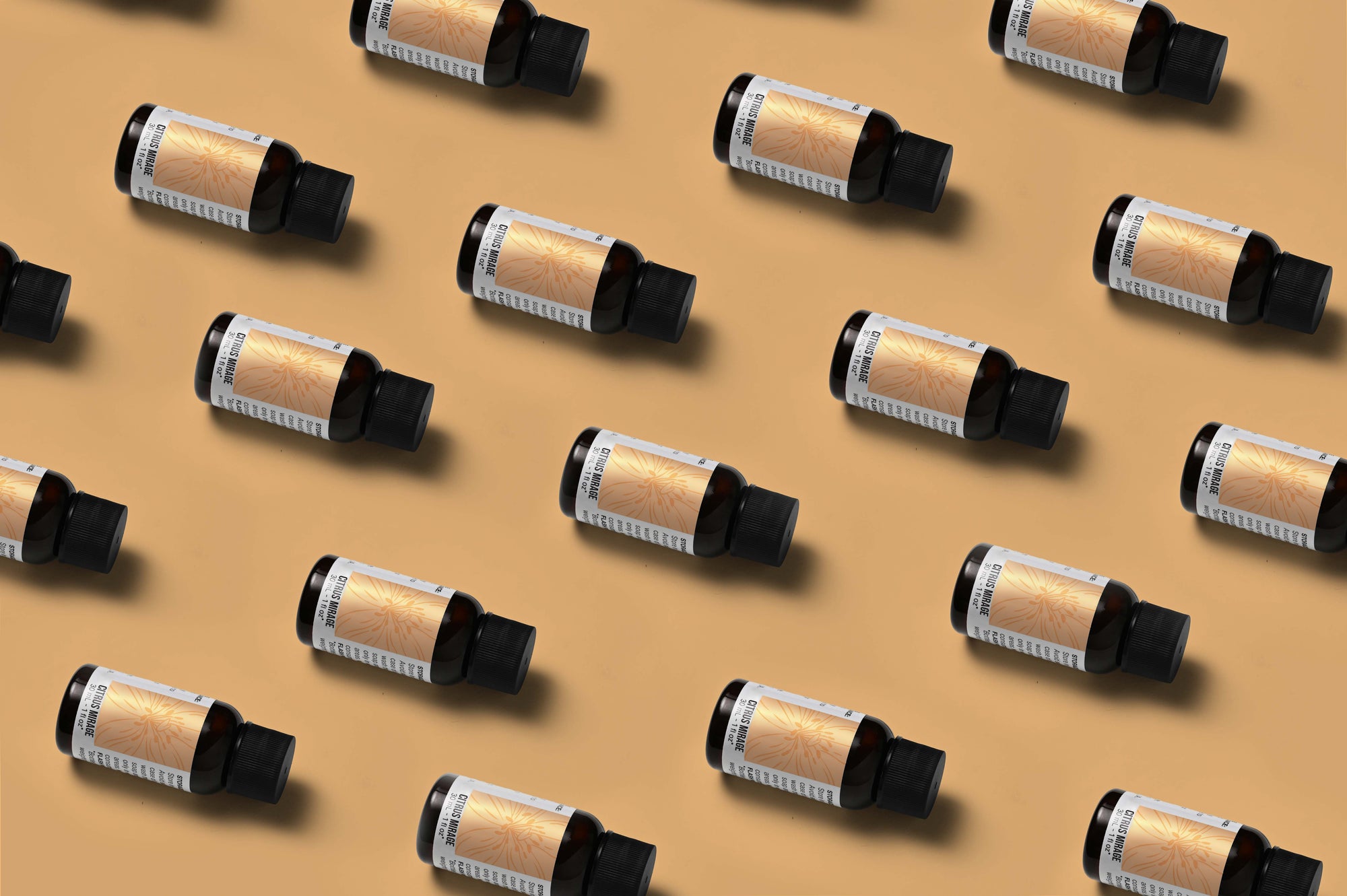 Pattern of Citrus Mirage fragrance oil bottles on a light orange background
