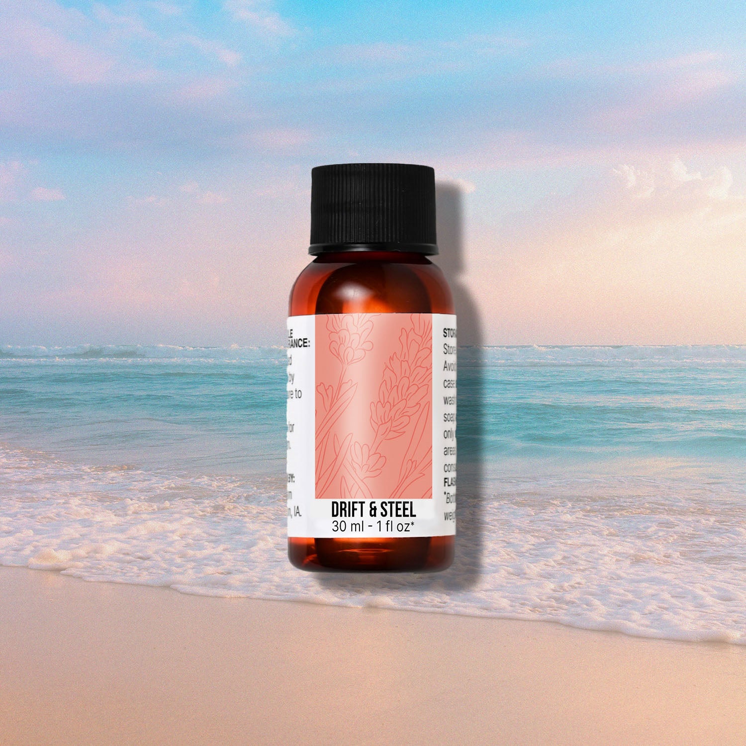 Bottle of Drift & Steel fragrance oil on a beach background