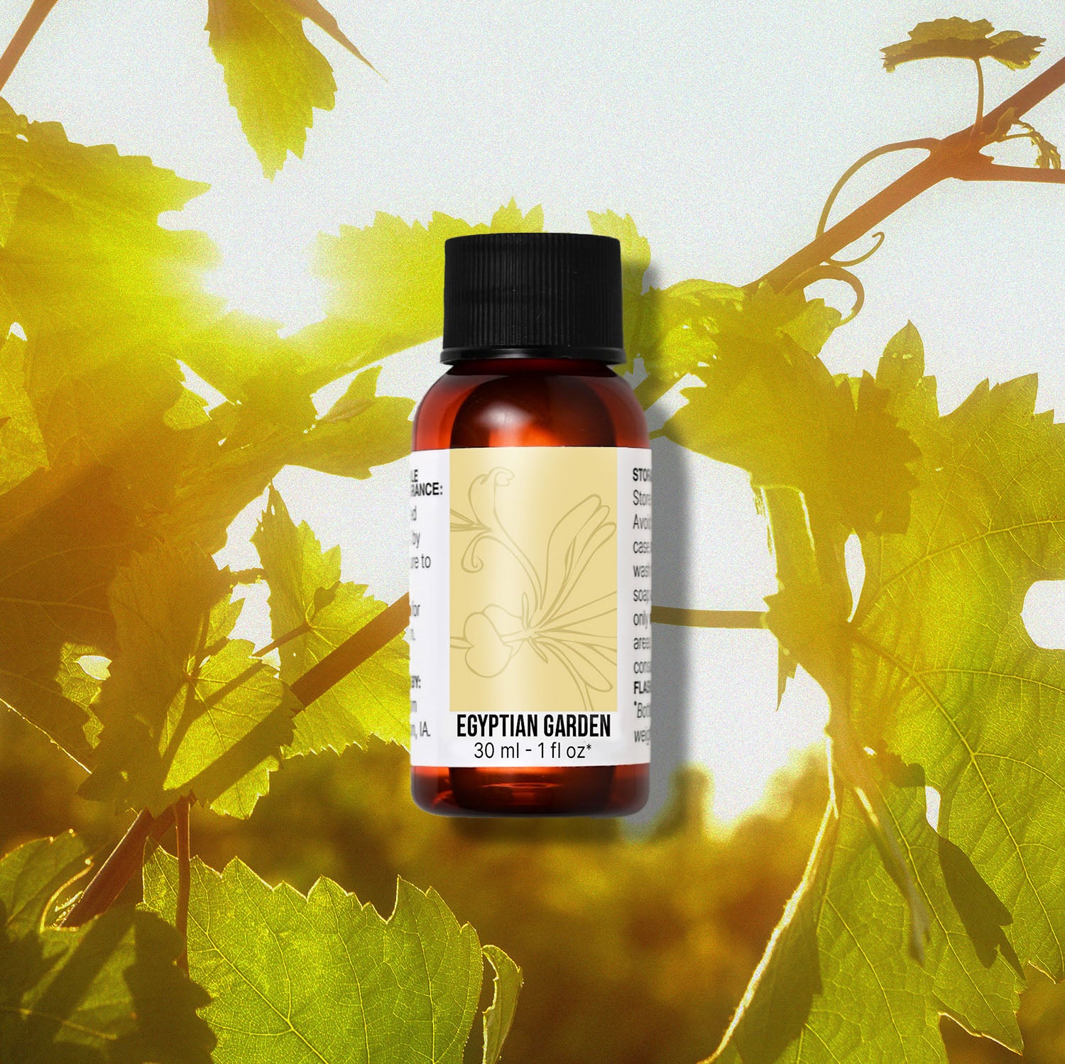 Bottle of Egyptian Garden fragrance oil with green leaves in the background