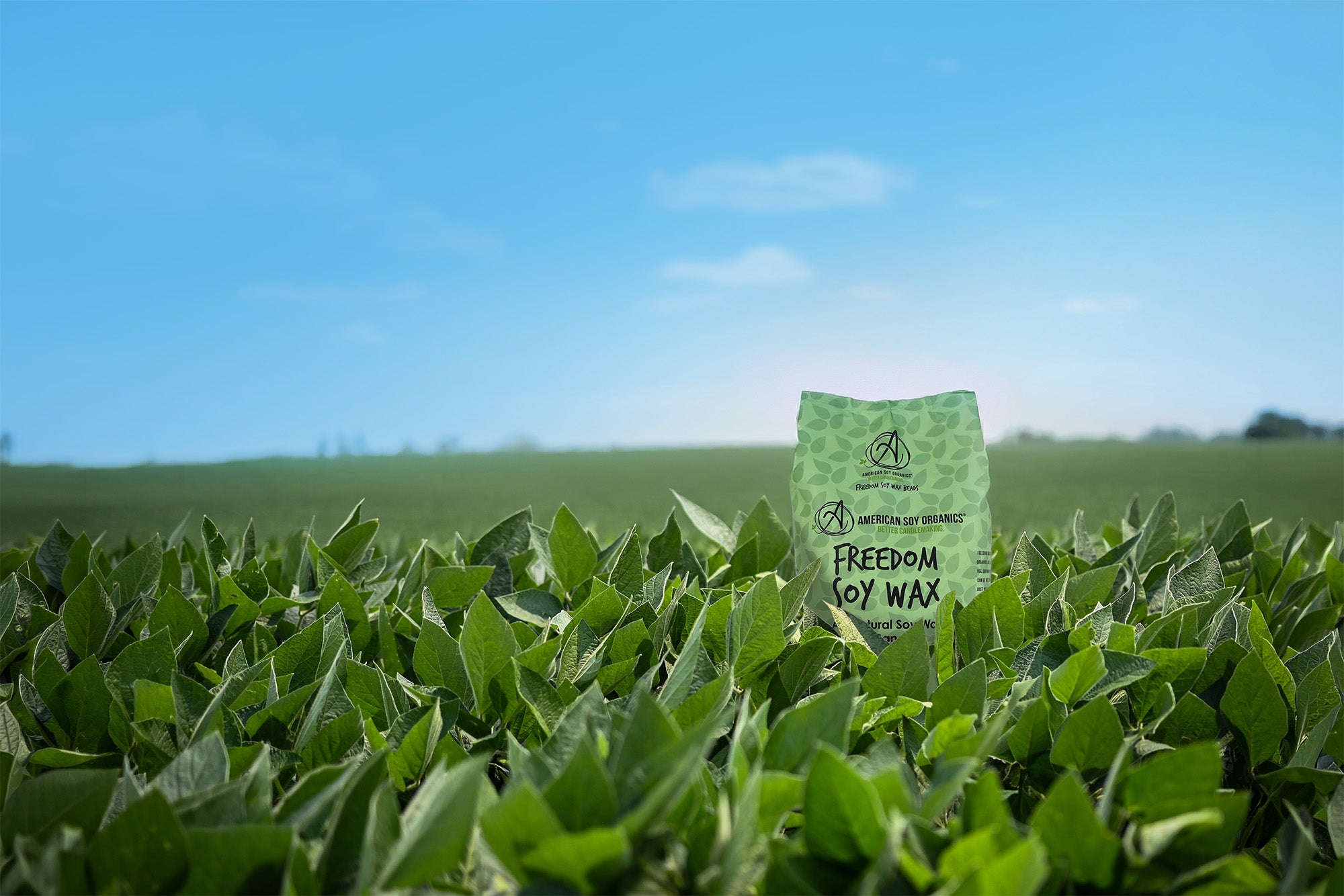 Bag of Freedom Soy Wax in a field with a clear blue sky