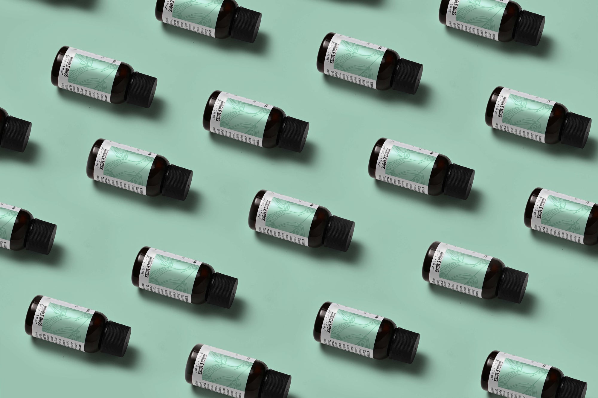 Pattern of Jungle Moss fragrance oil bottles on a light green background
