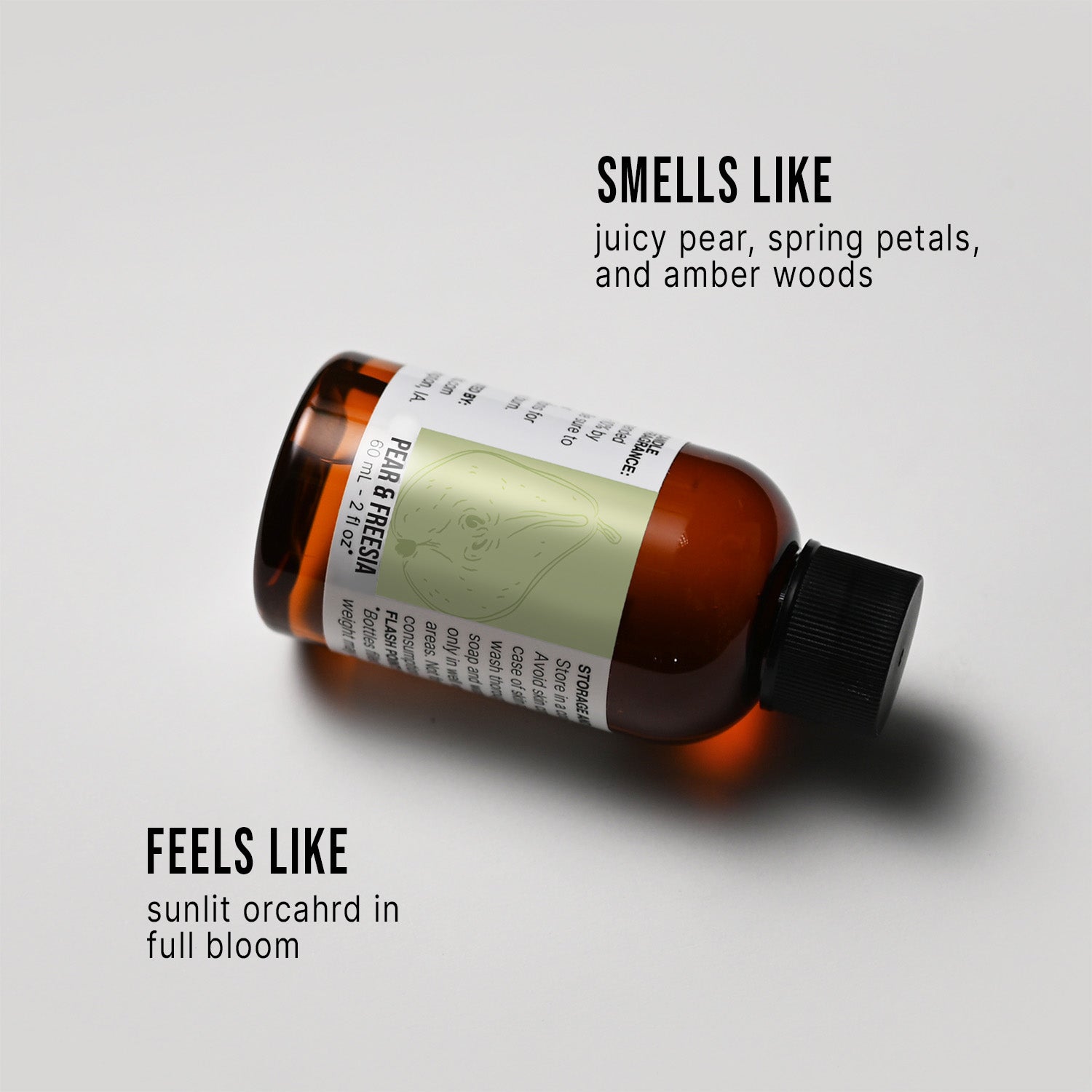 Bottle of Pear & Freesia fragrance oil with a label on a white background, describing its scent.