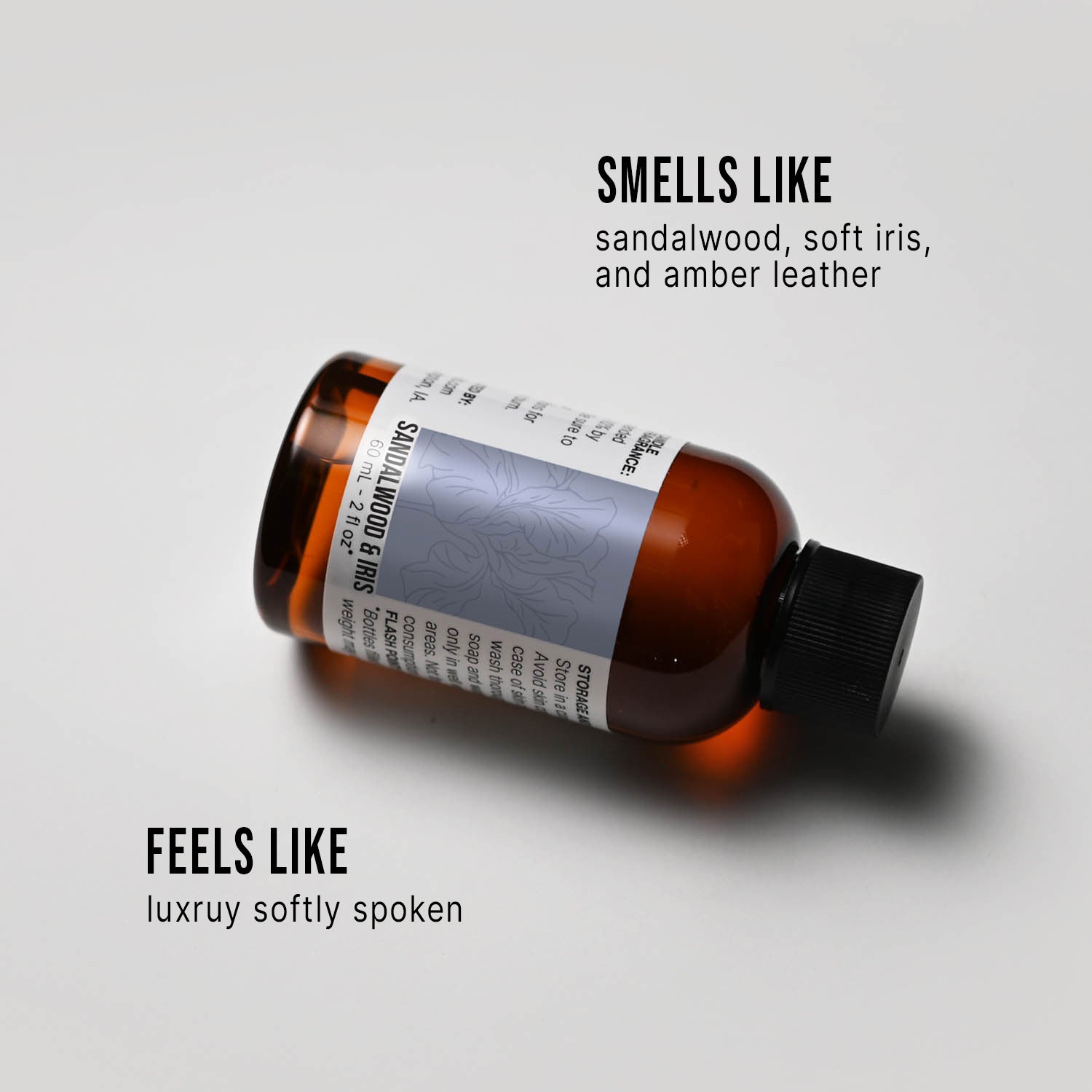 Bottle of Sandalwood & Iris fragrance oil with a label on a white background, describing its scent.