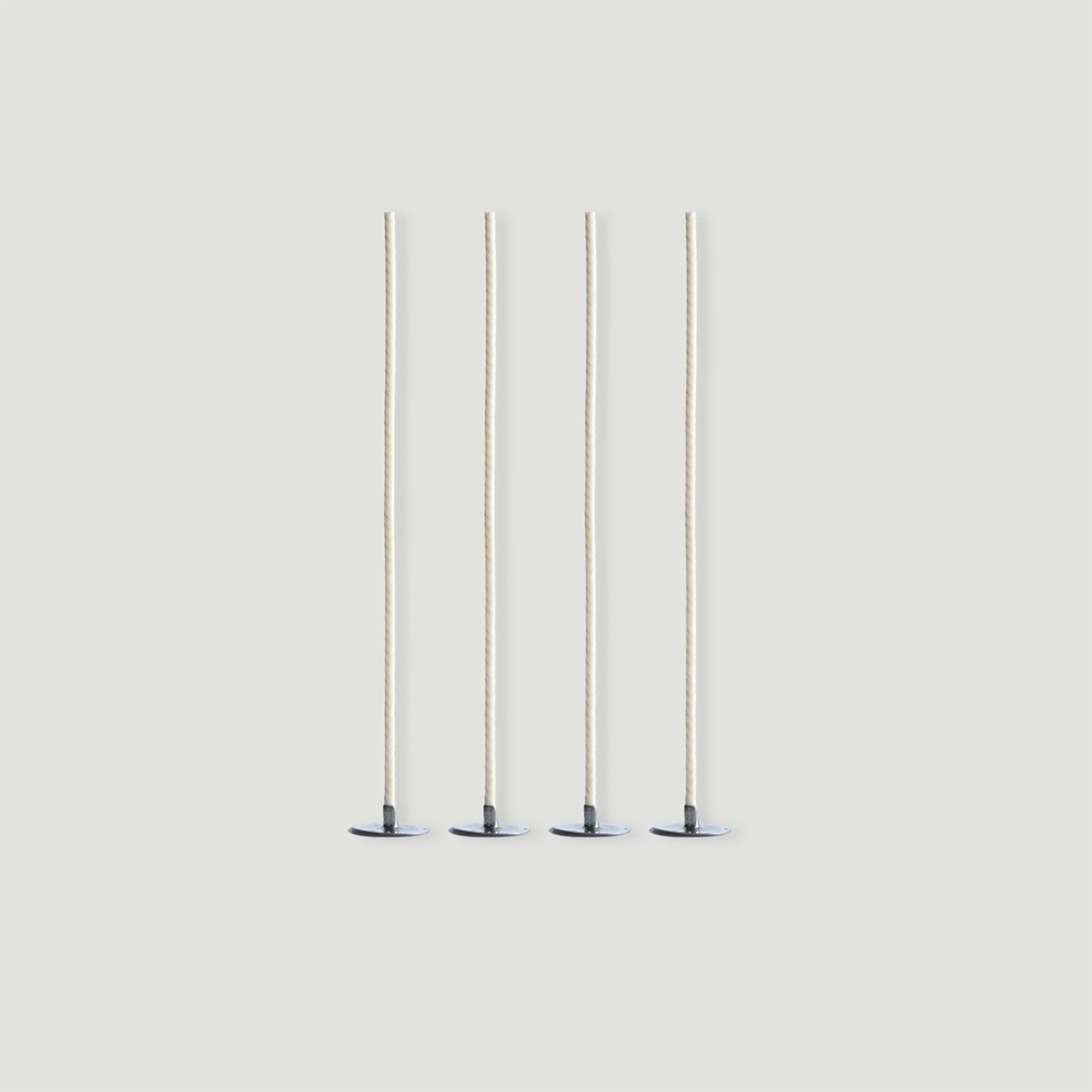 Four candle wicks on a plain background. 