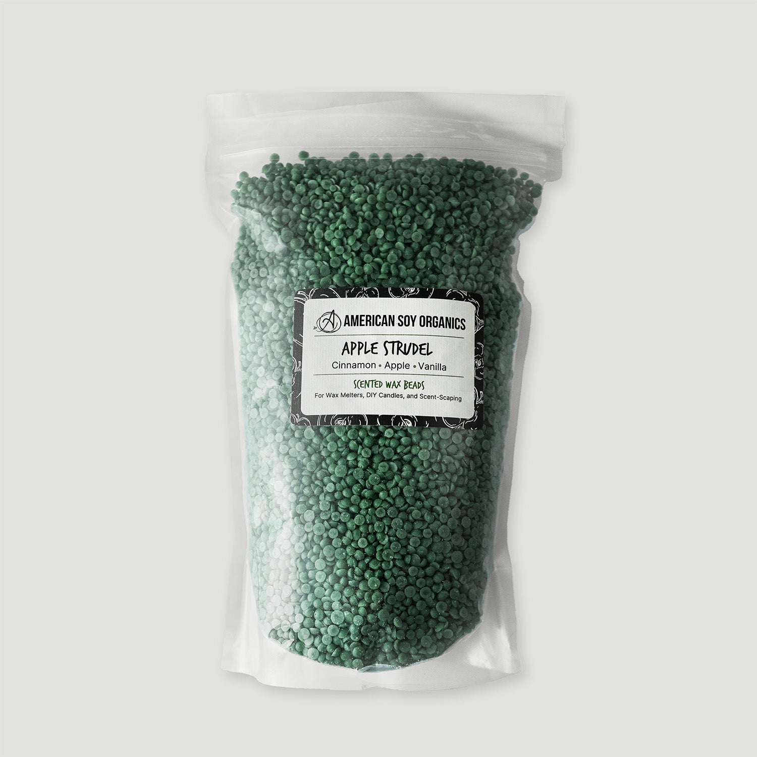 Bag of green wax beads with a label on a white background