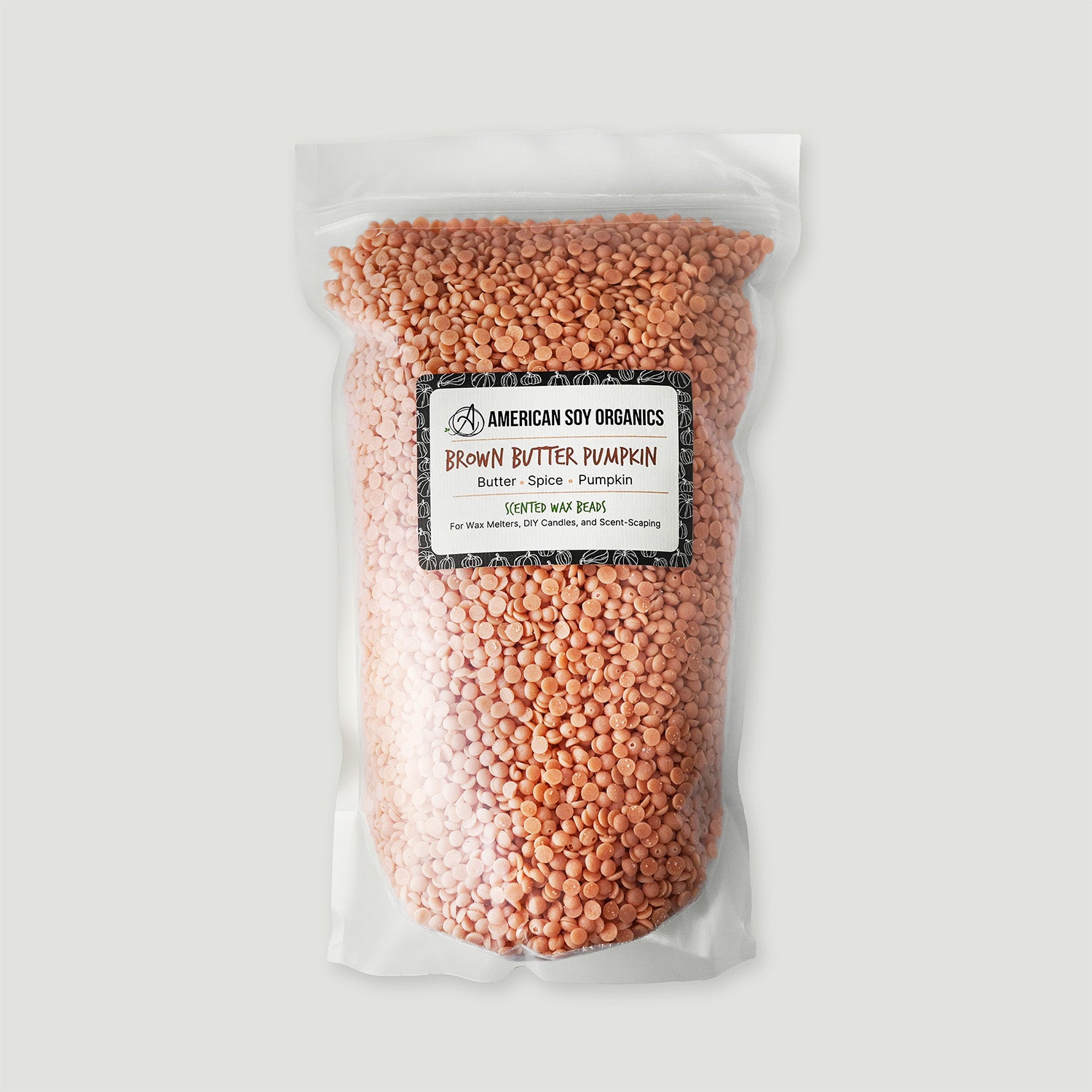 Bag of brown butter pumpkin wax beads with a label on a white background