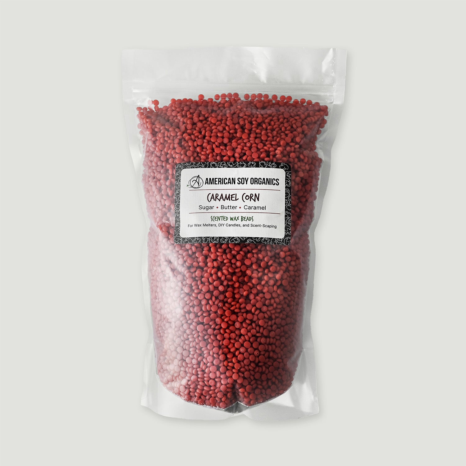 Bag of red caramel corn wax beads with an American Soy Organics label on a white background