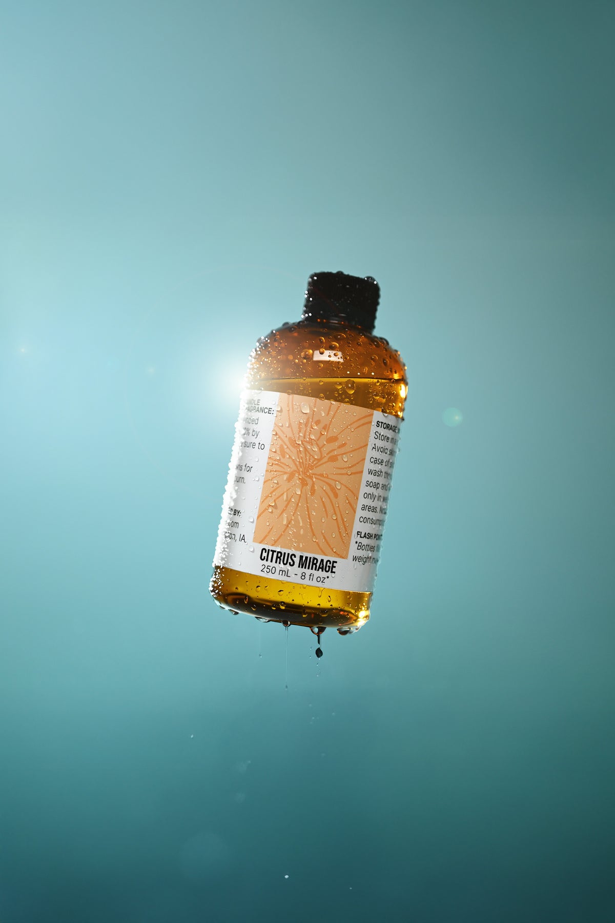 Bottle of Citrus Mirage oil with a label on a blue gradient background