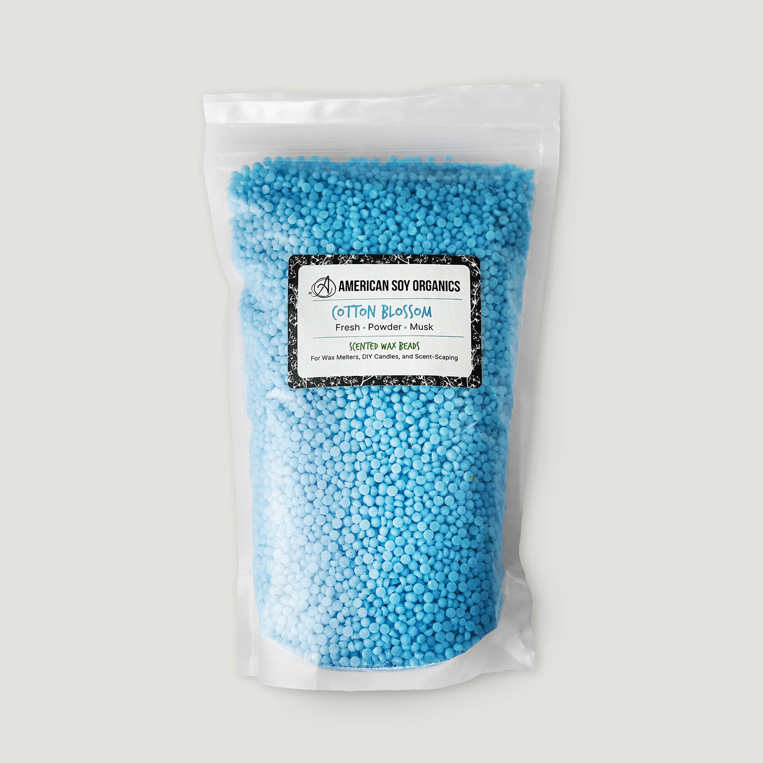 Bag of blue wax beads with a label on a white background