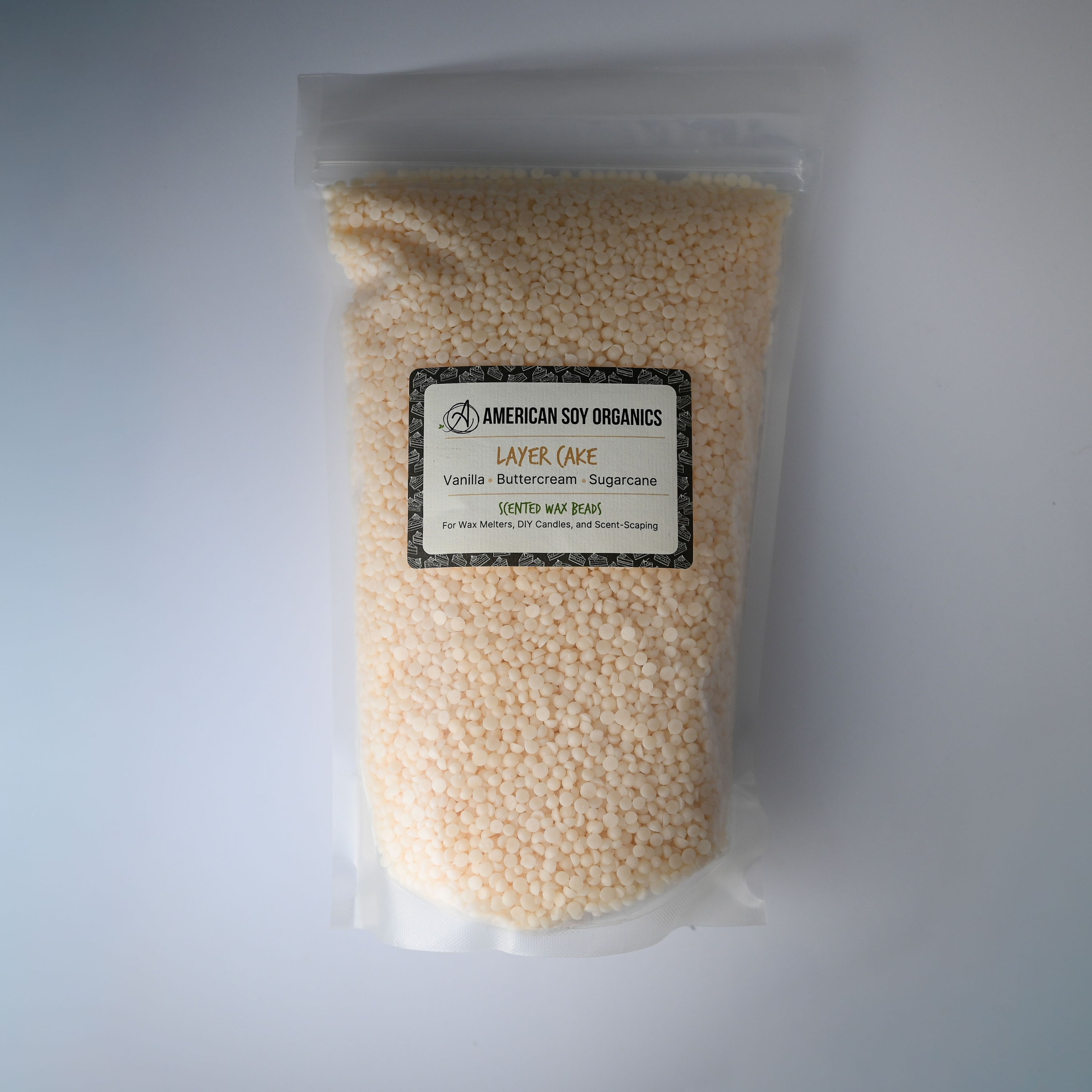 Bag of Layer Cake American Soy Organics scented wax beads on a white background