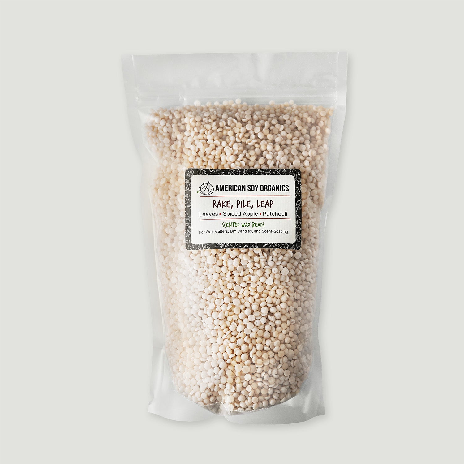 Clear bag of scented wax beads with a label on a light gray background