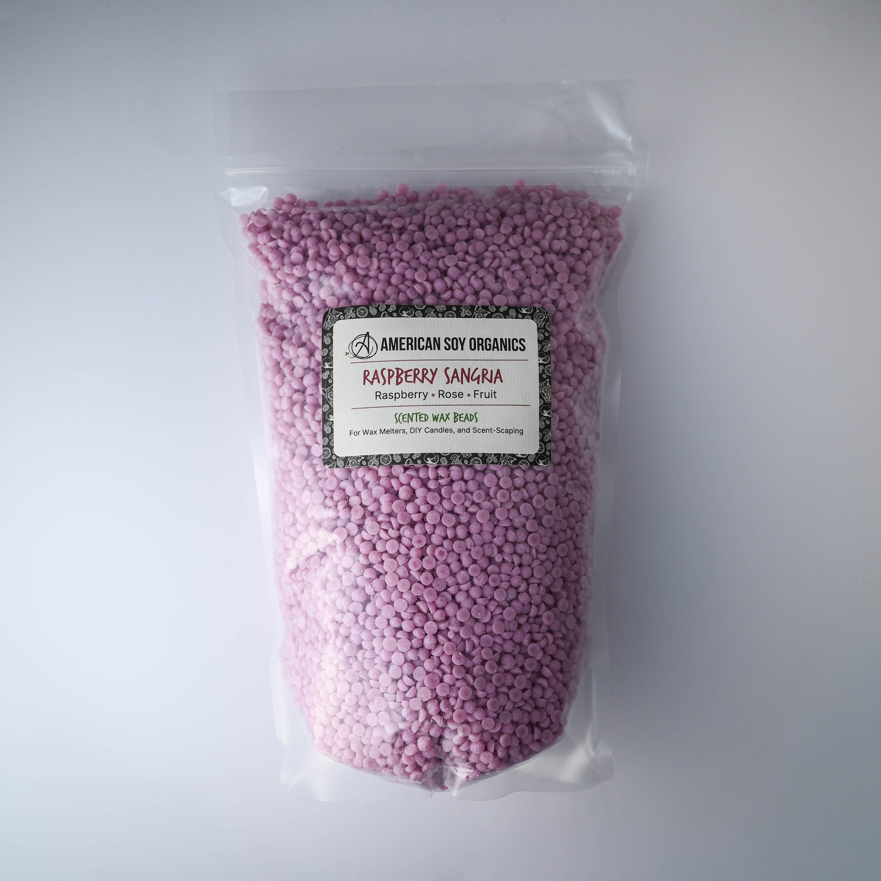 Bag of pinkish purple wax beads with a raspberry sangria label on a white background